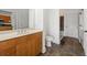 Bathroom with wood cabinets, a tile floor and a combined shower/tub at 425 Chapel Sw St # 1211, Atlanta, GA 30313