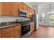 Kitchen with stainless steel appliances, granite counters, and wood cabinets at 425 Chapel Sw St # 1211, Atlanta, GA 30313