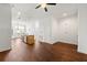 Spacious living room with hardwood floors, view into kitchen, and door to patio at 425 Chapel Sw St # 1211, Atlanta, GA 30313