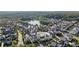 Aerial view of the community featuring the property at 6820 Colfax Ave, surrounded by lush greenery and a nearby lake at 6820 Colfax Ave, Cumming, GA 30040