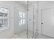 Bright bathroom featuring a glass shower and shuttered window at 6820 Colfax Ave, Cumming, GA 30040