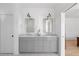 Bright bathroom featuring dual vanity with marble countertop and modern lighting at 6820 Colfax Ave, Cumming, GA 30040