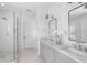 Bright bathroom featuring dual vanity with marble countertop and glass shower at 6820 Colfax Ave, Cumming, GA 30040