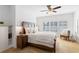 Serene bedroom with natural light, a ceiling fan, and a cozy chair, offering a relaxing retreat at 6820 Colfax Ave, Cumming, GA 30040