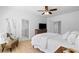 Bright bedroom featuring hardwood floors, ceiling fan, a chair, and an ensuite bath at 6820 Colfax Ave, Cumming, GA 30040