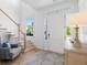 Bright entryway with staircase, large front door, and decorative lamp at 6820 Colfax Ave, Cumming, GA 30040