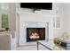 The marble fireplace is surrounded by shuttered windows bringing in natural light at 6820 Colfax Ave, Cumming, GA 30040