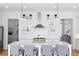 Bright, white kitchen featuring a central island with seating and open shelving at 6820 Colfax Ave, Cumming, GA 30040