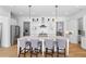 Bright kitchen with a large center island, pendant lighting, stainless appliances, and open shelving at 6820 Colfax Ave, Cumming, GA 30040