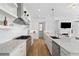 Bright kitchen features stainless steel appliances, white cabinetry, and marble countertops at 6820 Colfax Ave, Cumming, GA 30040