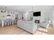 Open concept living room boasts a fireplace and a chef's kitchen with island seating at 6820 Colfax Ave, Cumming, GA 30040