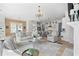 Bright open concept living room with kitchen, fireplace, and neutral furniture at 6820 Colfax Ave, Cumming, GA 30040
