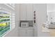 Pantry boasts white cabinets, marble countertop, and shelves with a view out to the window at 6820 Colfax Ave, Cumming, GA 30040