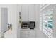 Charming pantry features white cabinets, marble countertop, and shelving with natural light at 6820 Colfax Ave, Cumming, GA 30040