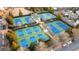 Aerial shot showcases pristine tennis and pickleball courts surrounded by greenery at 6820 Colfax Ave, Cumming, GA 30040