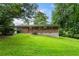 Spacious backyard featuring a brick home exterior and lush green lawn at 2775 Belleau Se Ln, Atlanta, GA 30316