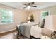Bright bedroom with hardwood floors, ceiling fan, and ample natural light from two windows at 2775 Belleau Se Ln, Atlanta, GA 30316