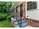 Charming home entrance with brick accents, black railings, and freshly painted steps at 2775 Belleau Se Ln, Atlanta, GA 30316