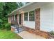 Charming home entrance with brick accents, black railings, and freshly painted steps at 2775 Belleau Se Ln, Atlanta, GA 30316