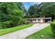 Charming single-story home with mature trees, a long driveway, and well-maintained lawn at 2775 Belleau Se Ln, Atlanta, GA 30316