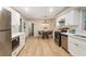 Bright kitchen featuring stainless steel appliances, white cabinets, and an adjacent dining area with stylish lighting at 2775 Belleau Se Ln, Atlanta, GA 30316