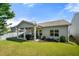A spacious backyard with a covered patio, outdoor seating, and lush landscaping at 5318 Burrus Ln, Mableton, GA 30126