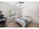Bedroom features neutral carpet, ceiling fan, and a computer desk for convenience at 5318 Burrus Ln, Mableton, GA 30126