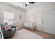 Cozy Bedroom with a comfortable rocking chair, a whimsical rainbow mural, and a crib at 5318 Burrus Ln, Mableton, GA 30126