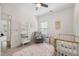 Comfortable Bedroom features a crib, decoratove ladder, and large window at 5318 Burrus Ln, Mableton, GA 30126