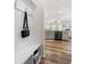 Functional entryway features beadboard with hooks and bench leading to the kitchen at 5318 Burrus Ln, Mableton, GA 30126