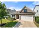Attractive home with a two-car garage, brick facade, manicured lawn, and vibrant landscaping at 5318 Burrus Ln, Mableton, GA 30126