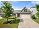 Charming brick home featuring a two-car garage, manicured lawn, and beautiful landscaping at 5318 Burrus Ln, Mableton, GA 30126