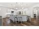 Open kitchen featuring a large island with bar seating, white cabinetry, and stainless steel appliances at 5318 Burrus Ln, Mableton, GA 30126