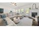 Comfortable living room boasts a fireplace, large sectional, plush rug, and ample natural light at 5318 Burrus Ln, Mableton, GA 30126