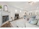 Bright living room featuring a cozy fireplace, sectional sofa, wood floors, and modern decor at 5318 Burrus Ln, Mableton, GA 30126