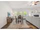 Open-concept living space with a dining area, fireplace, hardwood floors, and a sectional sofa at 5318 Burrus Ln, Mableton, GA 30126