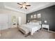 Cozy main bedroom featuring a decorative wall, ceiling fan, and large window at 5318 Burrus Ln, Mableton, GA 30126