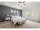 Main bedroom with decorative wall, ceiling fan, and natural light at 5318 Burrus Ln, Mableton, GA 30126
