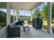 A relaxing covered patio with comfortable seating and an outdoor grill at 5318 Burrus Ln, Mableton, GA 30126