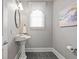Charming powder room features pedestal sink, modern fixtures, and neutral decor at 1605 Pavillion Ridge Se Dr, Smyrna, GA 30080