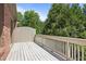 Spacious wooden deck surrounded by lush greenery offers serene outdoor living and entertaining at 1605 Pavillion Ridge Se Dr, Smyrna, GA 30080