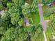 Aerial perspective of the home with a well-manicured lawn, surrounded by mature trees and greenery at 162 Nouveau Sw Ct, Lilburn, GA 30047