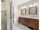 Bathroom featuring a double vanity with granite countertops and a tiled walk-in shower at 162 Nouveau Sw Ct, Lilburn, GA 30047