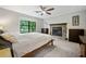 Bedroom featuring a fireplace, large windows providing ample light, and neutral decor at 162 Nouveau Sw Ct, Lilburn, GA 30047