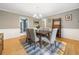 Elegant dining room with stylish furniture, hardwood floors, and a contemporary chandelier at 162 Nouveau Sw Ct, Lilburn, GA 30047