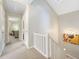 Upstairs hallway with white railings, neutral walls, and access to the attic at 162 Nouveau Sw Ct, Lilburn, GA 30047