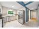 Bright kitchen featuring stainless steel appliances, granite countertops, and white cabinets at 162 Nouveau Sw Ct, Lilburn, GA 30047