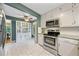 Eat-in kitchen features stainless appliances and adjoins an eating area and Gathering room at 162 Nouveau Sw Ct, Lilburn, GA 30047