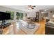 Bright living room with hardwood floors, a large rug, and sliding glass doors to a backyard deck at 162 Nouveau Sw Ct, Lilburn, GA 30047