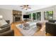 Cozy living room featuring a stone fireplace, hardwood floors, and sliding doors to the outdoor deck at 162 Nouveau Sw Ct, Lilburn, GA 30047